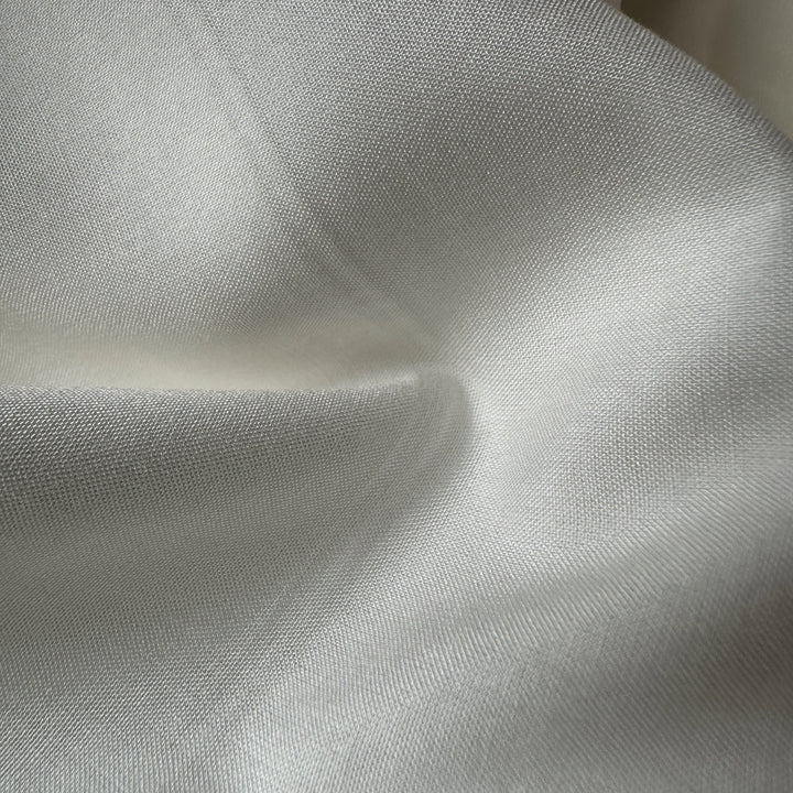 Close-up of 100% Aloe Vera plain fabric showing breathable plant-based textile texture for eco apparel.