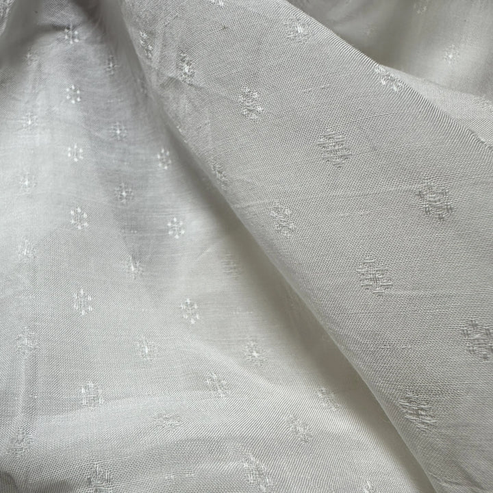 Banana fabric displayed with natural elements like leaves and flowers