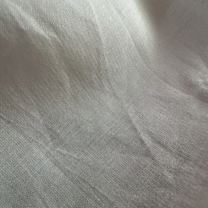 Lightweight bamboo cotton fabric draped naturally, ideal for sleepwear, linings, and comfort apparel