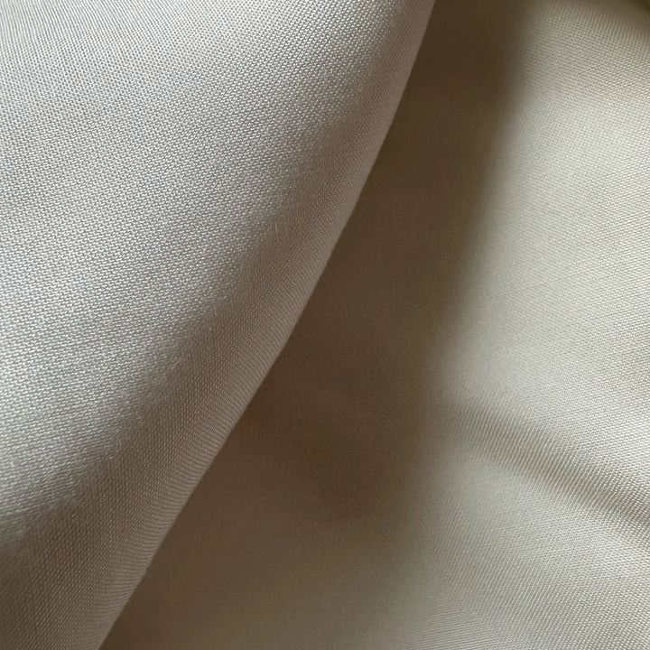 Close-up of 70% bamboo and 30% lyocell sustainable fabric with silky texture for conscious fashion brands.