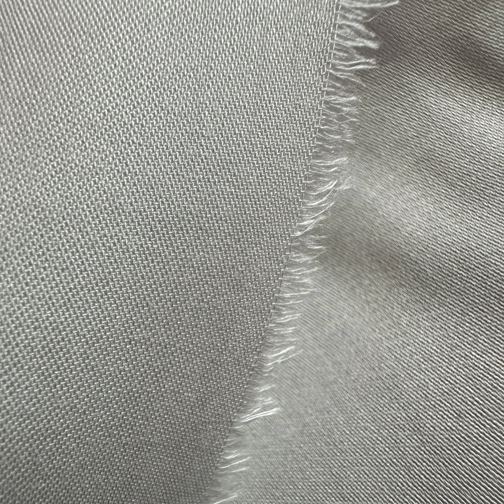 Close-up of organic corn satin weave showing smooth sheen and fine texture
