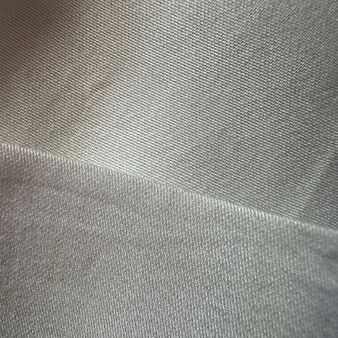 Close-up of organic eucalyptus satin weave showing smooth sheen and fine texture