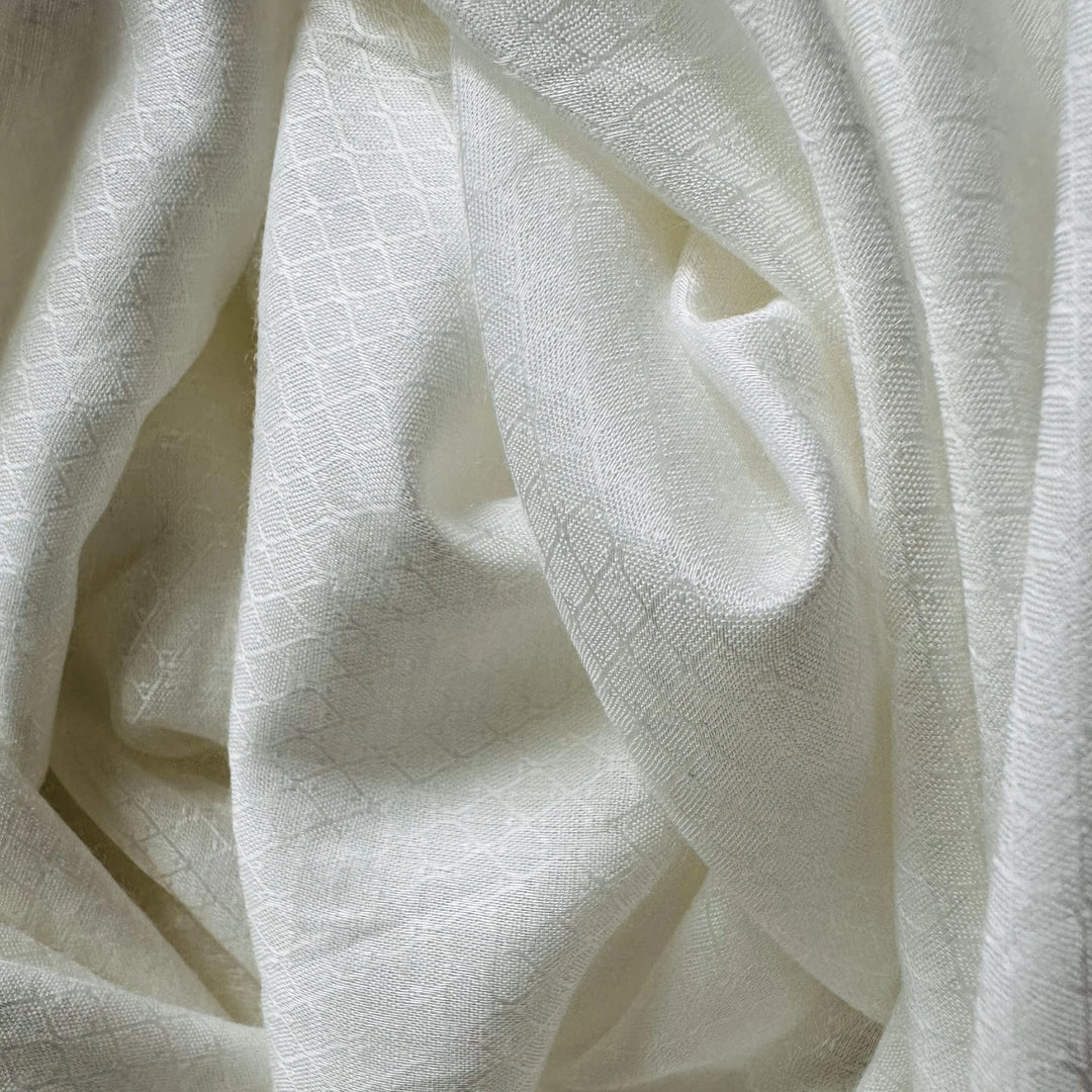 Fabric rolls of Jasmine cellulose stacked in a textile studio