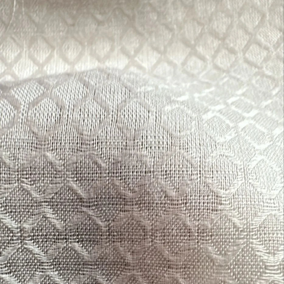 Hand holding lightweight and breathable Jasmine cellulose textile