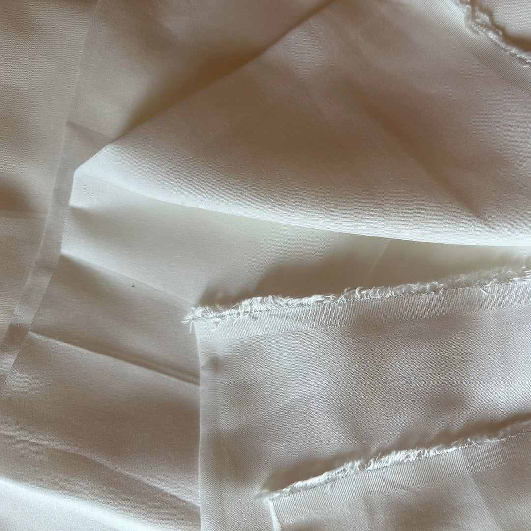 Lotus fiber satin fabric GSM 110 with smooth texture for sustainable fashion and natural textile sourcing.