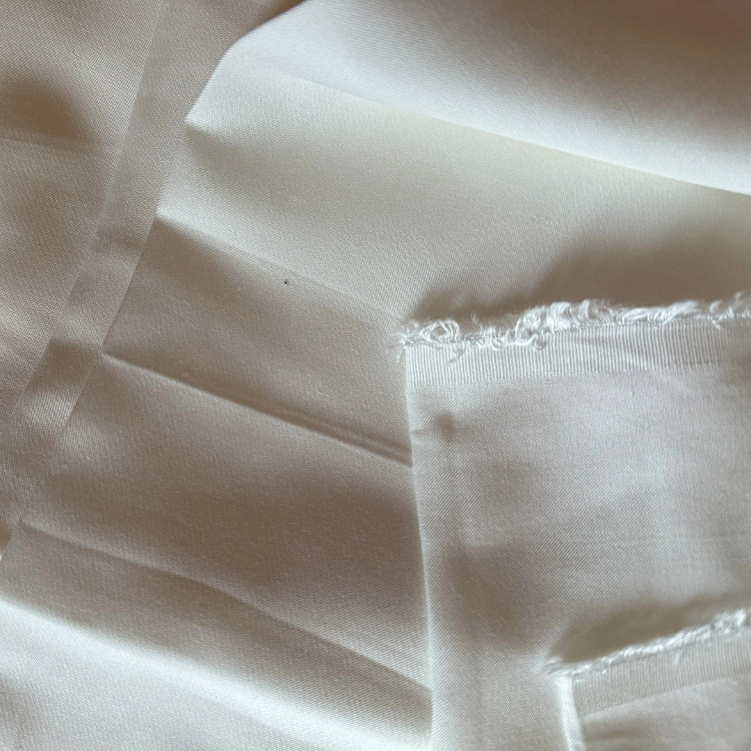 Close-up of Lotus fiber satin fabric 110 GSM showing soft sheen and plant-based textile texture