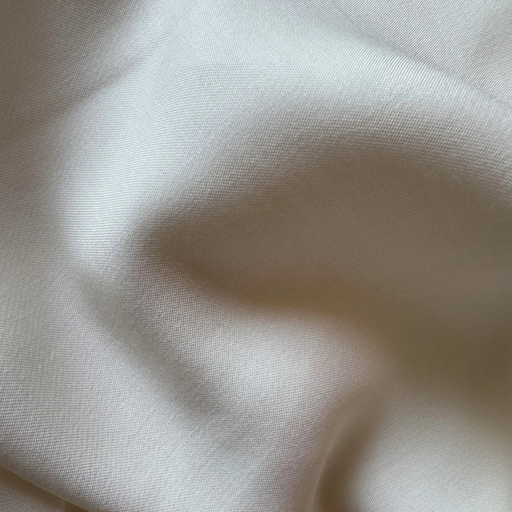 Lotus fiber satin fabric with elegant satin finish and lightweight 110 GSM texture for sustainable clothing