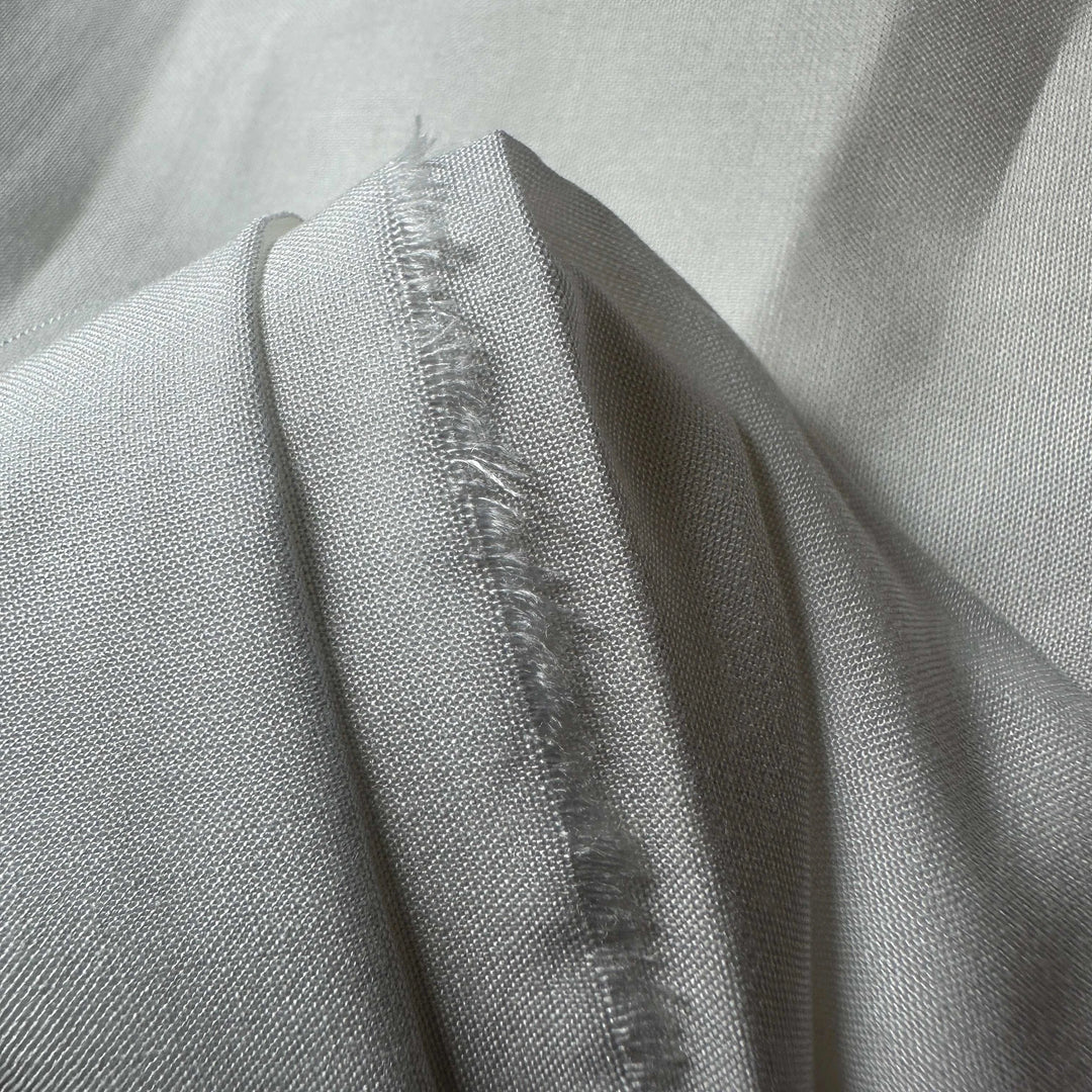 Natural lotus fiber fabric with a delicate, lightweight texture and soft sheen.
