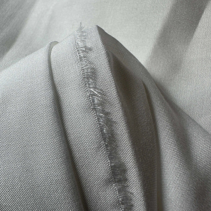 Natural lotus fiber fabric with a delicate, lightweight texture and soft sheen.