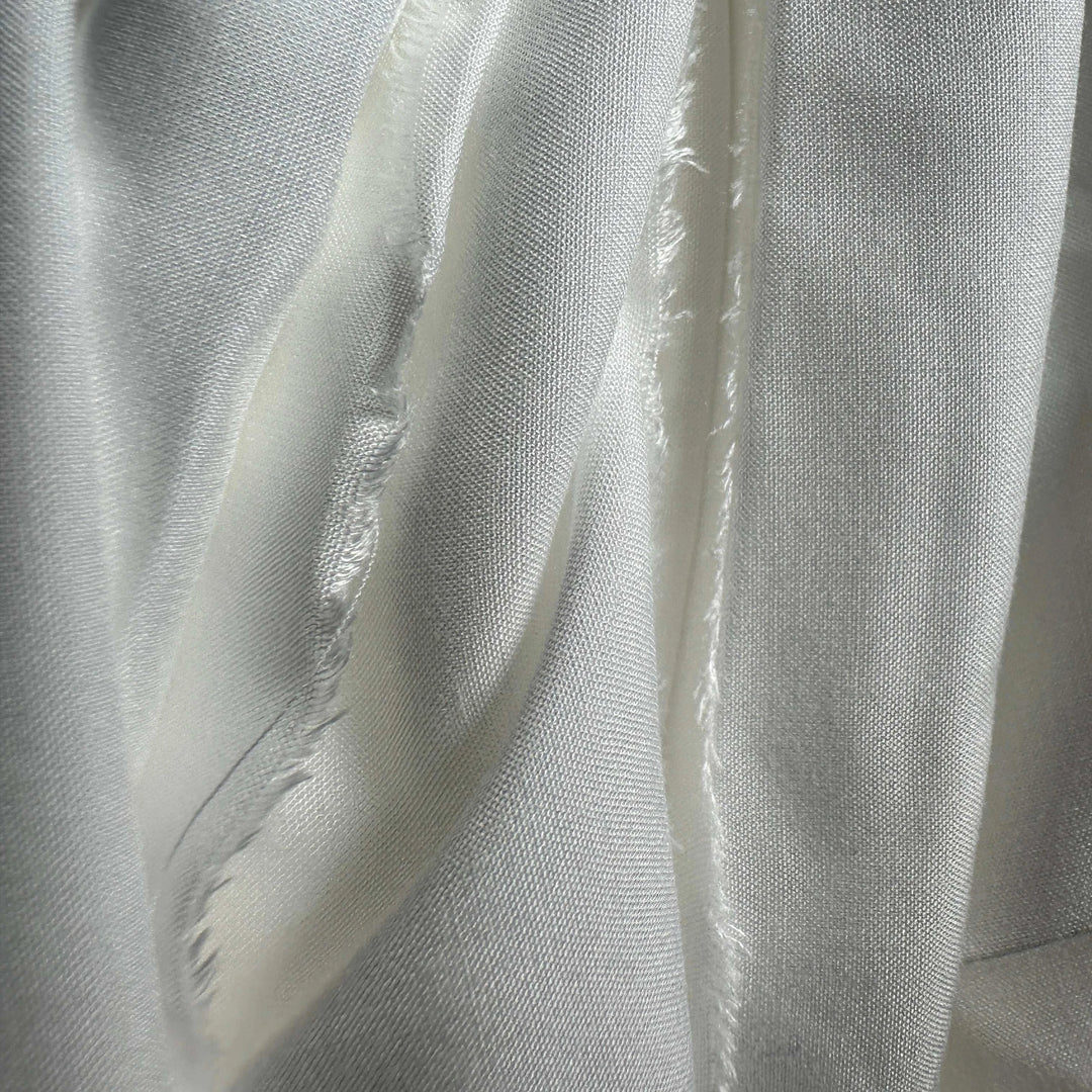 Close-up of handwoven lotus fabric showing fine, breathable weave pattern.