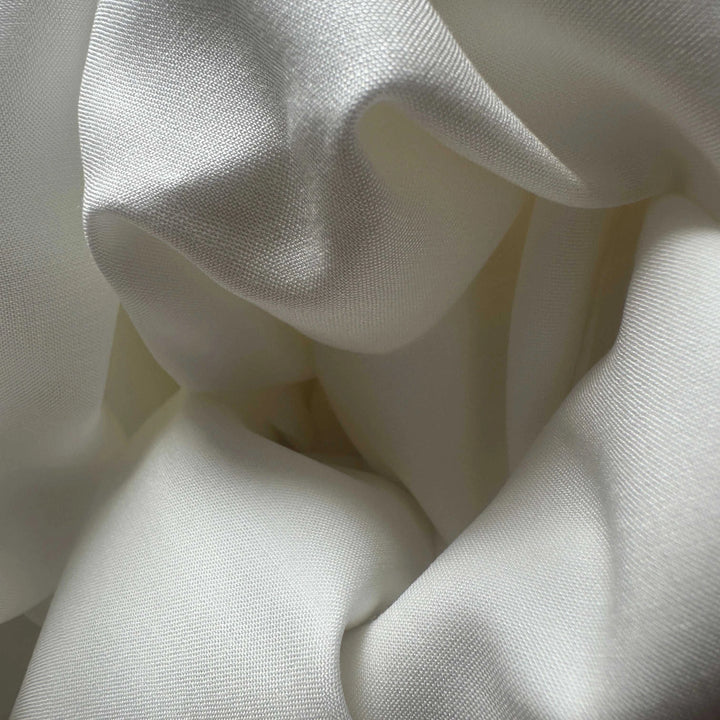 Elegant drape of lotus fabric highlighting its smooth flow and subtle texture.