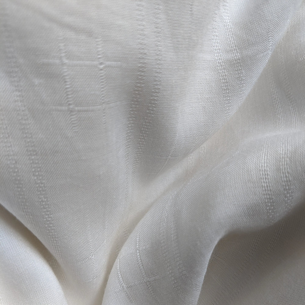 Detail shot of organic milk cellulose textile highlighting fine texture.
