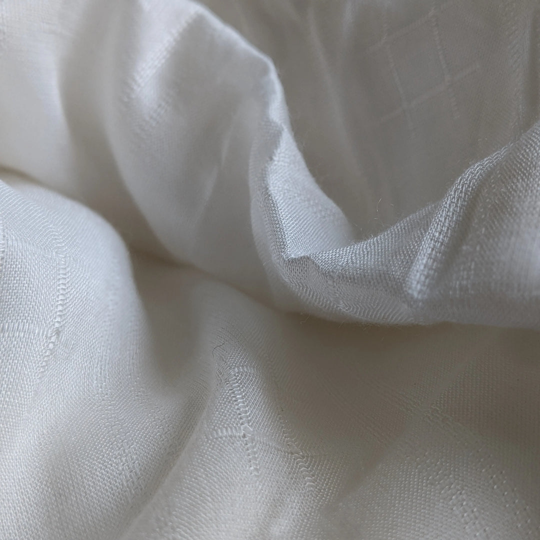 Detail shot of organic milk cellulose textile highlighting fine texture.