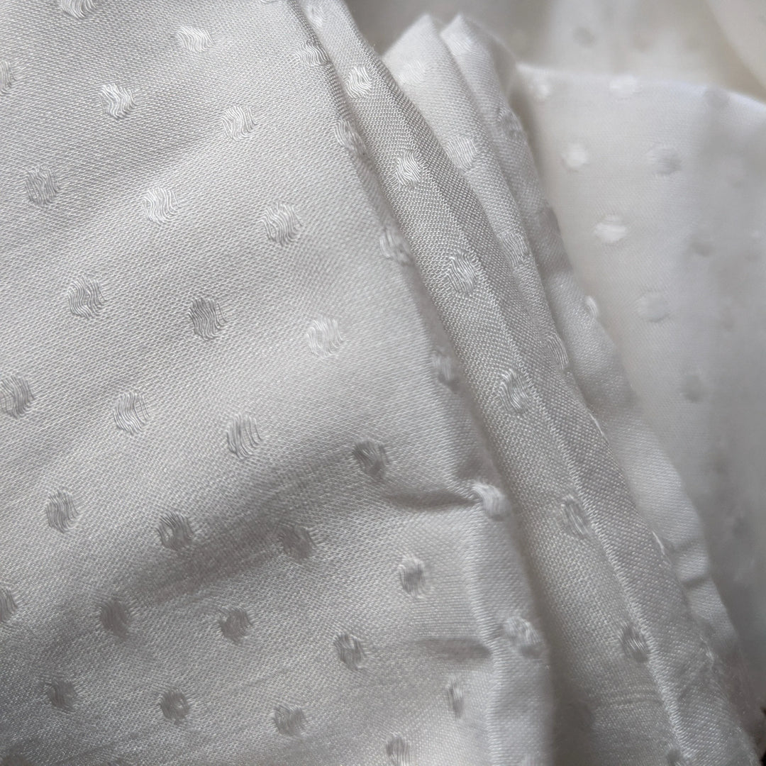 Close-up view of milk cellulose fabric highlighting its smooth, silky texture.