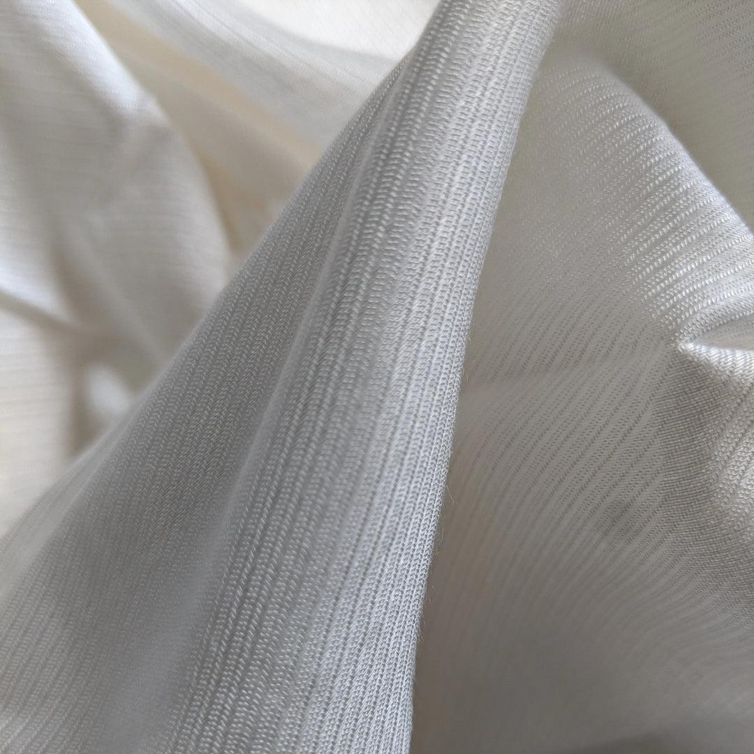 Textured shot of milk fiber fabric, highlighting its lightweight weave.