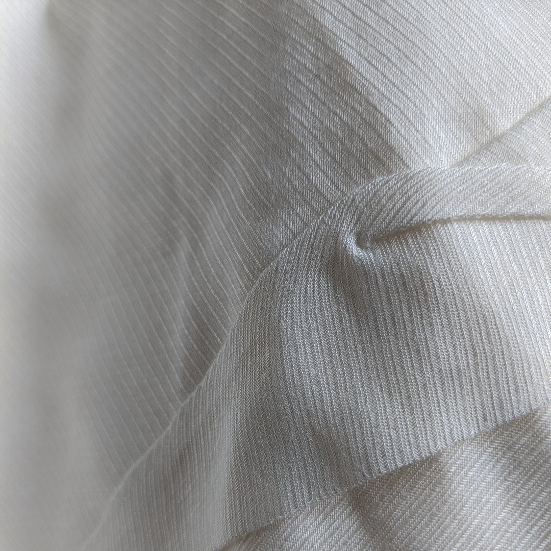 Milk cellulose fabric folded neatly, emphasizing its natural luster.