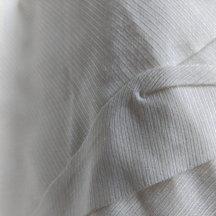 Milk cellulose fabric folded neatly, emphasizing its natural luster.