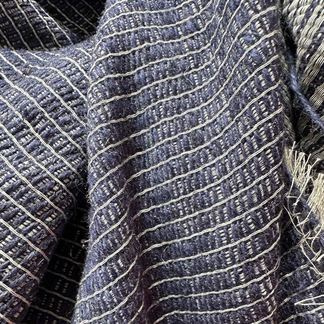 Textured view of eco-dyed Himalayan nettle fabric in natural yarn shades