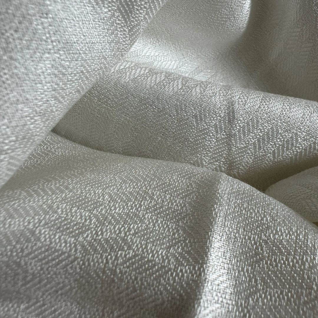 Lightweight 100% olive cellulose fabric with smooth surface and soft drape for apparel use.