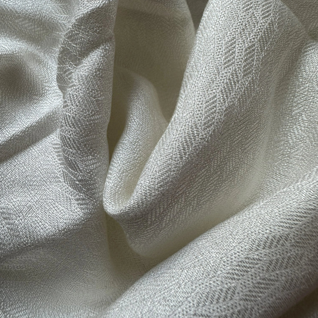 Undyed olive cellulose fabric made from olive plant waste, ready for eco-friendly dyeing.