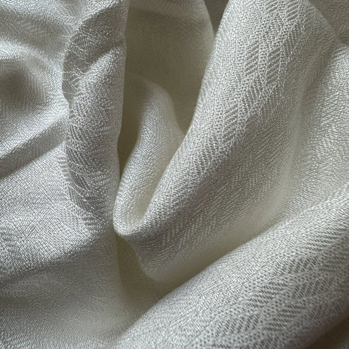 Undyed olive cellulose fabric made from olive plant waste, ready for eco-friendly dyeing.