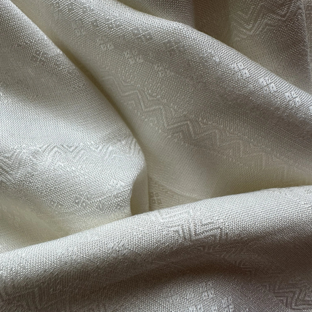 Natural plant-based olive cellulose fabric compatible with azo-free dyeing methods.