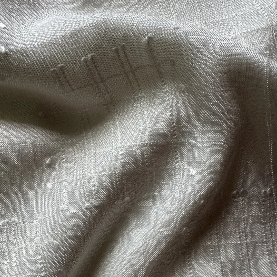 Undyed olive cellulose fabric ready for custom dyeing by ethical fashion brands.