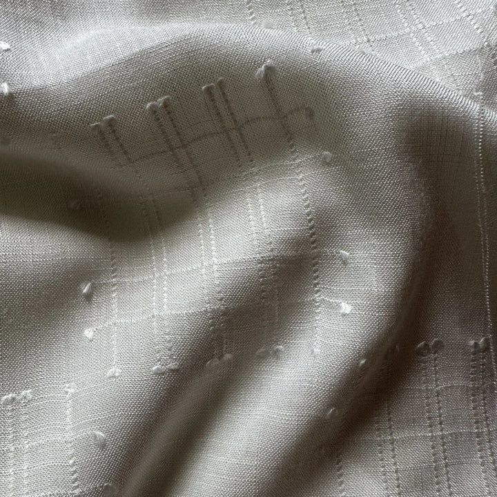 Undyed olive cellulose fabric ready for custom dyeing by ethical fashion brands.