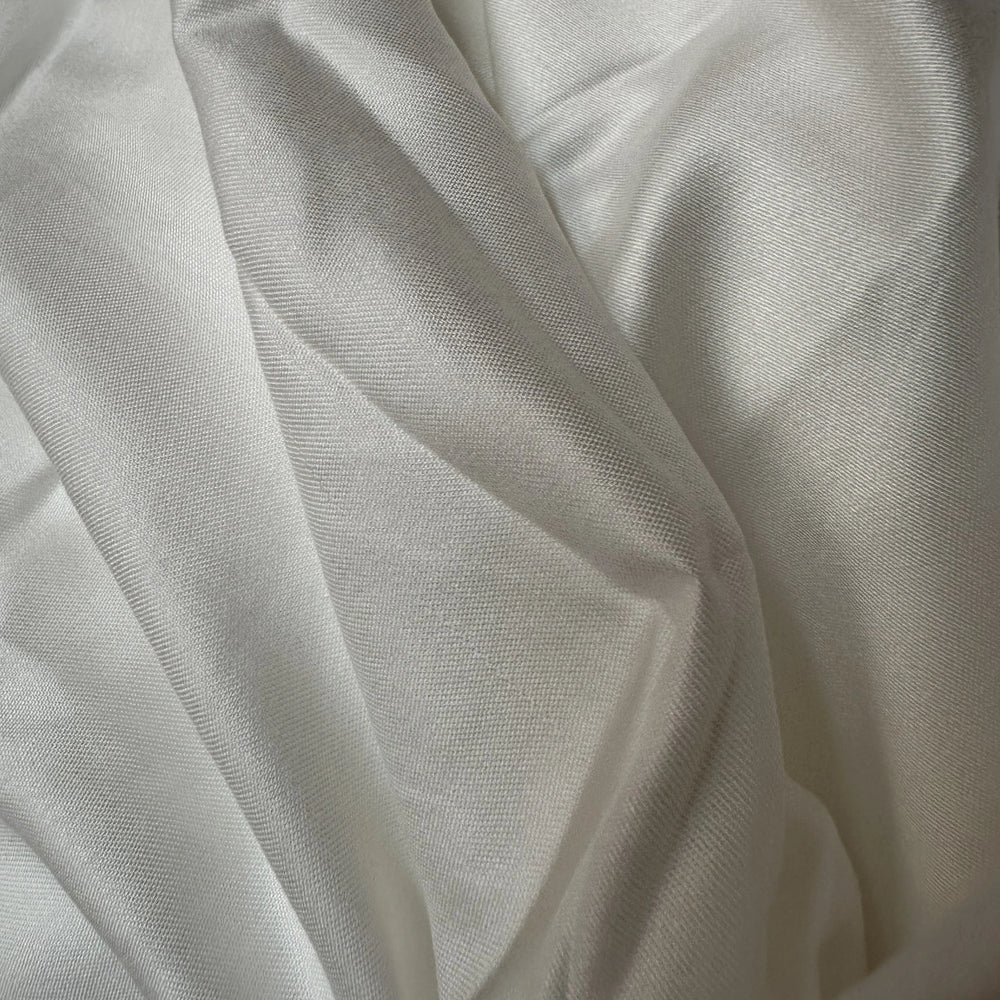 Pineapple leaf fiber satin fabric 130 GSM sustainable textile soft sheen surface detail.