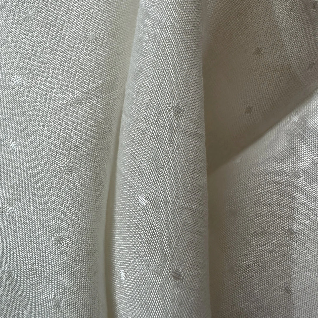 Close-up of 100% organic rose petal fiber fabric showing a soft, silk-like texture suitable for sustainable fashion brands