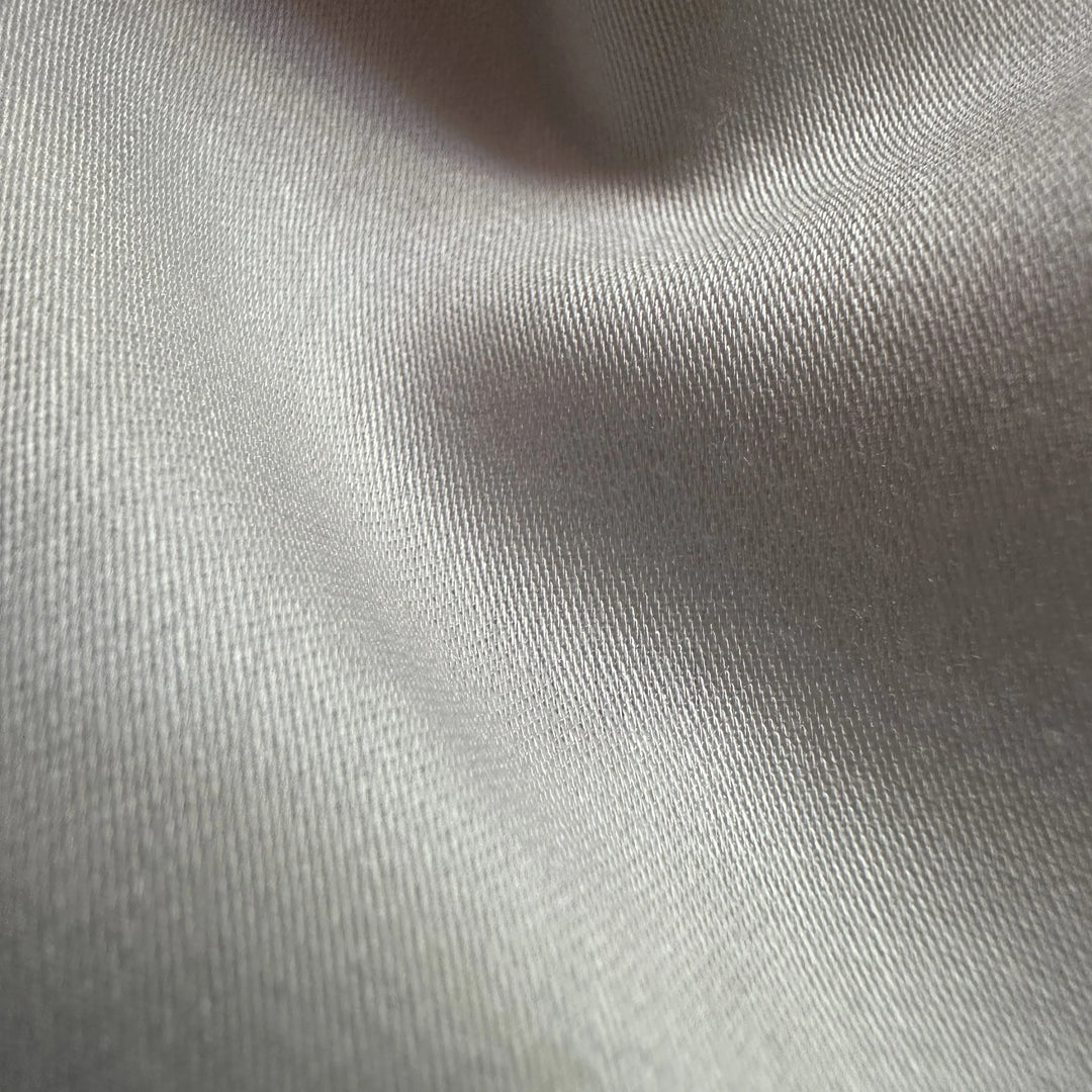 Close-up of organic soybean fiber satin weave showing glossy front and matte back texture