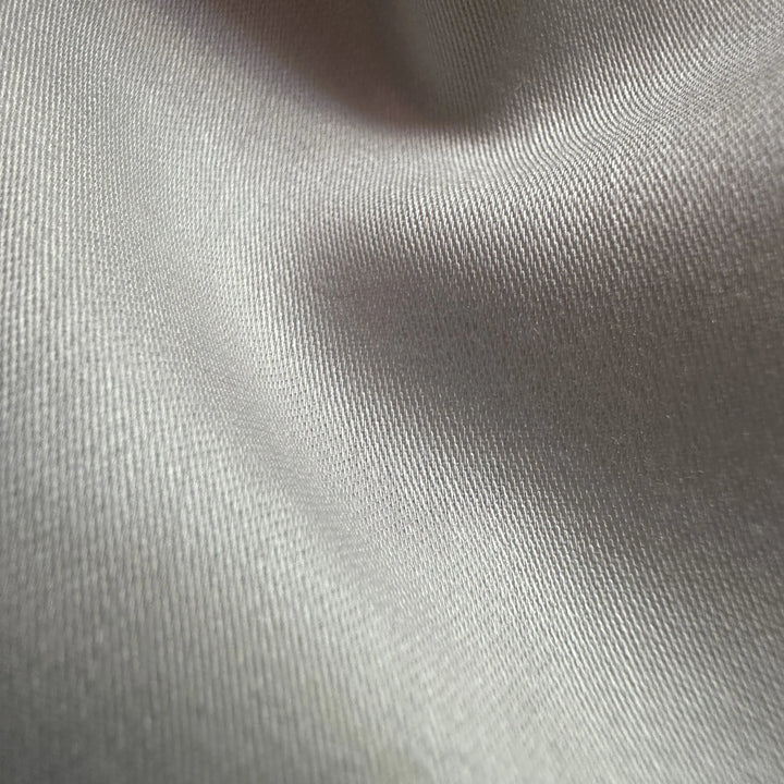 Close-up of organic soybean fiber satin weave showing glossy front and matte back texture
