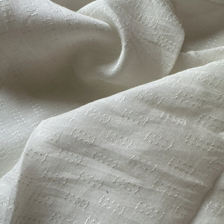 Close up of sustainable soybean fabric showing clean weave and soft hand feel