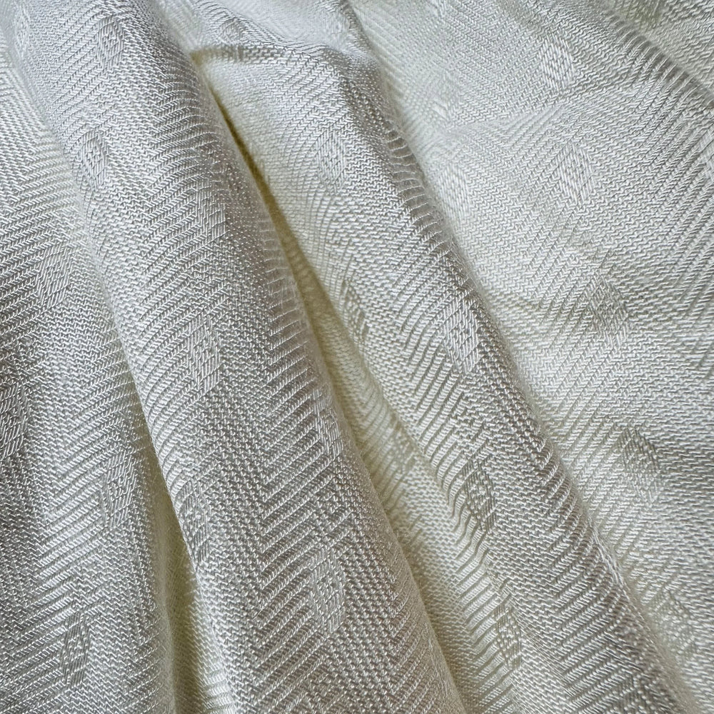 Rolled 100% sugarcane fiber fabric in beige color on a wooden surface