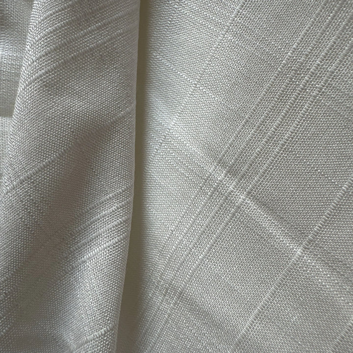 Close up of organic sugarcane fiber fabric showing natural texture and lightweight weave.
