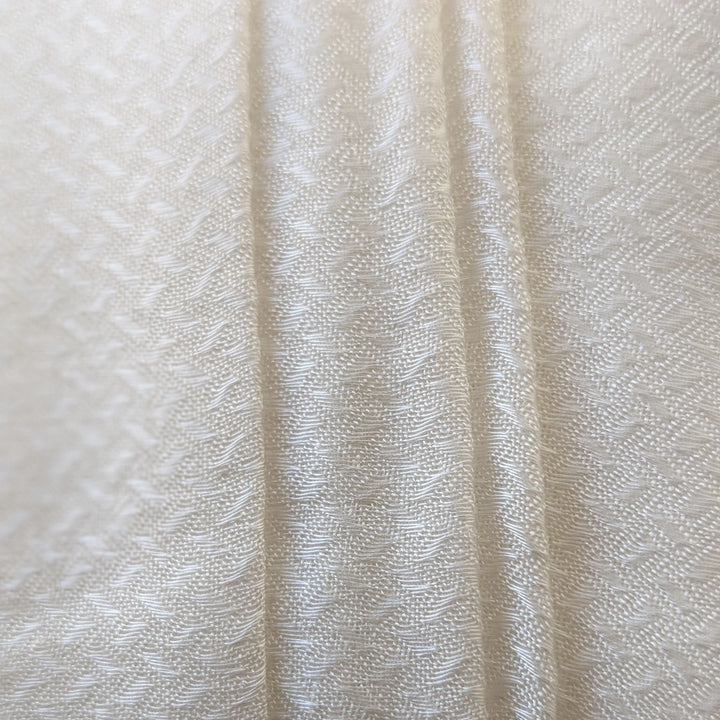 Sugarcane fabric swatches in various natural tones under sunlight