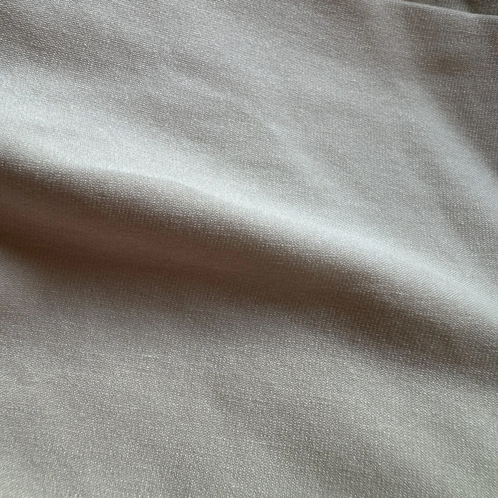 Plant-based sugarcane spandex knit fabric showing smooth surface and gentle elasticity