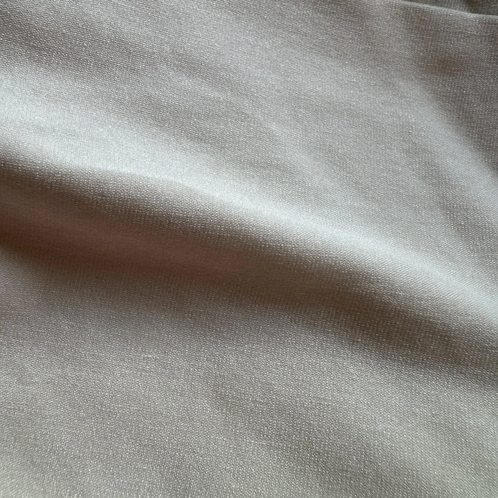 Plant-based sugarcane spandex knit fabric showing smooth surface and gentle elasticity