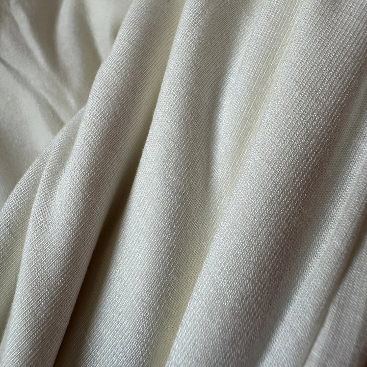Buy aloe vera-infused spandex knitted fabric, highlighting its texture and subtle sheen.