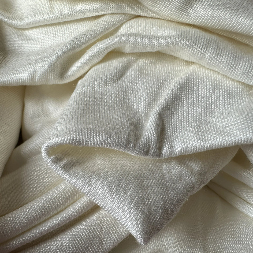 Soft 100% aloe vera single jersey knit fabric with smooth surface, stretch comfort, and natural wellness touch.