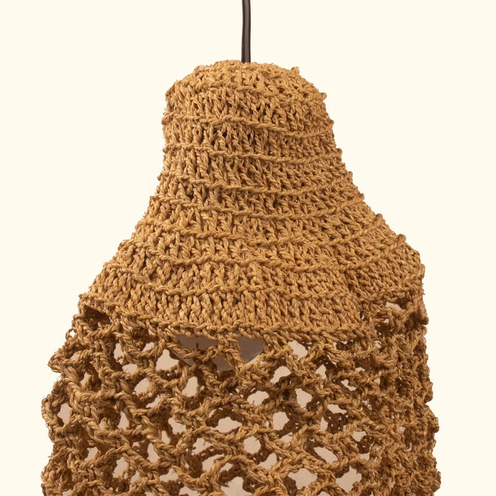 Skilled artisan crafting wheat grass lamp shade by hand